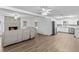 Open-concept layout flows to the kitchen, featuring brick fireplace, vinyl floors, and white cabinets at 3610 Donna St, Port Orange, FL 32129