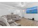 Bright living room features neutral walls, wood floors, and a comfy sectional sofa for relaxation at 3610 Donna St, Port Orange, FL 32129