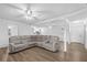 Open-concept living room with hardwood floors, neutral walls, and a sectional sofa, bathed in natural light at 3610 Donna St, Port Orange, FL 32129
