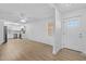 Bright living room offers wood floors, white walls, and an open layout to the updated kitchen at 3610 Donna St, Port Orange, FL 32129