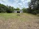 Large backyard with a detached building and space for outdoor activities at 3625 Pioneer Trl, New Smyrna Beach, FL 32168