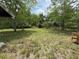 Spacious backyard with a mix of grass and foliage, offering privacy and a natural setting at 3625 Pioneer Trl, New Smyrna Beach, FL 32168