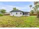 Back exterior view of the home showing a grassy yard at 3718 Paige St, Port Orange, FL 32129