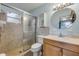 Cozy bathroom featuring a walk-in shower with glass door and a round mirror at 3718 Paige St, Port Orange, FL 32129