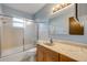 Bathroom featuring vanity and a shower-tub combo with glass doors at 3718 Paige St, Port Orange, FL 32129