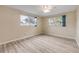 Bright bedroom with wood-look flooring and natural light from two windows at 3718 Paige St, Port Orange, FL 32129