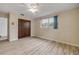 A simple bedroom with wood-look floors, a closet, and a window with blue curtains at 3718 Paige St, Port Orange, FL 32129