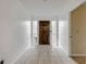 Bright foyer featuring a beautiful wood door, tile flooring, and white walls at 3718 Paige St, Port Orange, FL 32129