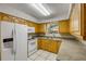 Well-lit kitchen with wooden cabinets and stainless steel appliances at 3718 Paige St, Port Orange, FL 32129