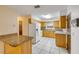 Bright kitchen boasts wooden cabinets, white appliances, and a breakfast bar at 3718 Paige St, Port Orange, FL 32129