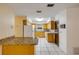 Kitchen with breakfast bar, tile floors, wood cabinets, and white appliances at 3718 Paige St, Port Orange, FL 32129