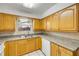 Kitchen featuring oak cabinets, a stainless steel sink, and neutral countertops at 3718 Paige St, Port Orange, FL 32129