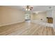 Spacious living area showcasing wood-look floors, a dining area, and access to the porch at 3718 Paige St, Port Orange, FL 32129