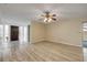 Spacious living area with modern wood-look flooring and a ceiling fan at 3718 Paige St, Port Orange, FL 32129