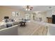 Open living room with a view of the dining area and sliding glass doors to the screened in porch at 3718 Paige St, Port Orange, FL 32129
