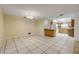 Open-concept living space with tile flooring, seamlessly connecting the kitchen and dining area at 3718 Paige St, Port Orange, FL 32129