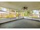 View of the screened porch showing windows and a fan at 3718 Paige St, Port Orange, FL 32129