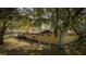 Aerial view showcasing brick house with fenced backyard and mature trees at 3736 Paige St, Port Orange, FL 32129