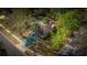 Aerial view of the property showcasing mature trees, landscaping, and painted driveway at 3736 Paige St, Port Orange, FL 32129