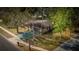Aerial view of a charming single-story home with mature trees, a driveway, and a well-maintained lawn at 3736 Paige St, Port Orange, FL 32129