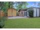 Spacious backyard featuring a patio area and storage shed, perfect for outdoor entertaining and relaxing at 3736 Paige St, Port Orange, FL 32129