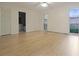 Bedroom features wood-look flooring, ceiling fan, access to bathroom and backyard through bright window at 3736 Paige St, Port Orange, FL 32129