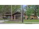 Charming brick home with attached garage, surrounded by mature trees and lush green lawn at 3736 Paige St, Port Orange, FL 32129