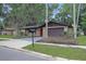 Charming single-story home with a brick facade, mature trees and a two-car garage at 3736 Paige St, Port Orange, FL 32129