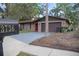 Lovely home with great curb appeal and an attached two-car garage, nestled among mature trees at 3736 Paige St, Port Orange, FL 32129