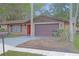 Inviting single-Gathering brick home featuring a two-car garage and beautiful trees in a serene setting at 3736 Paige St, Port Orange, FL 32129