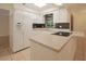 Well-lit kitchen with white appliances, black backsplash, and tile flooring, creating a functional and clean space at 3736 Paige St, Port Orange, FL 32129