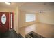 Inviting living room area with a bright window, hardwood floors, and an entryway with a decorative door at 3736 Paige St, Port Orange, FL 32129