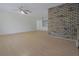 Spacious living room featuring neutral walls, light wood flooring, and brick accent wall at 3736 Paige St, Port Orange, FL 32129
