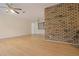 Spacious living room featuring wood laminate flooring and an eye-catching brick wall at 3736 Paige St, Port Orange, FL 32129