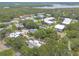 Aerial view showcases community nestled amongst lush trees and waterways at 3808 Saxon Dr, New Smyrna Beach, FL 32169