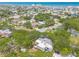 Aerial view showing rooftops among trees in the community at 3808 Saxon Dr, New Smyrna Beach, FL 32169