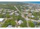 An aerial view captures a neighborhood near the coast, blending residential charm with natural beauty, and showcasing ocean views at 3808 Saxon Dr, New Smyrna Beach, FL 32169