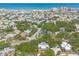 An aerial view highlights a coastal neighborhood's proximity to the ocean, showcasing lush landscapes and residential architecture at 3808 Saxon Dr, New Smyrna Beach, FL 32169