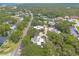 Aerial view of homes surrounded by trees lining neighborhood roads at 3808 Saxon Dr, New Smyrna Beach, FL 32169