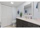 Bathroom with dark wood vanity, white countertop, and nautical themed decor at 3808 Saxon Dr, New Smyrna Beach, FL 32169