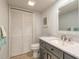 Bright bathroom featuring white vanity, decorative mirror, and tiled floor at 3808 Saxon Dr, New Smyrna Beach, FL 32169