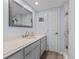 Clean bathroom with white countertop, gray vanity, and marble shower at 3808 Saxon Dr, New Smyrna Beach, FL 32169