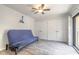 Bedroom featuring wood-look floors, large closet, ceiling fan and balcony access at 3808 Saxon Dr, New Smyrna Beach, FL 32169