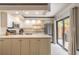 Charming kitchen featuring white cabinets, stainless steel appliances, and sliding glass doors at 3808 Saxon Dr, New Smyrna Beach, FL 32169