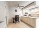 Eat-in kitchen with white cabinets, stone countertops, and stainless steel appliances at 3808 Saxon Dr, New Smyrna Beach, FL 32169