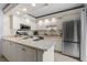 Bright kitchen with stainless appliances, light cabinets, and tile floors at 3808 Saxon Dr, New Smyrna Beach, FL 32169