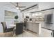 Eat-in kitchen features white cabinets, stainless appliances, and a cozy dining area at 3808 Saxon Dr, New Smyrna Beach, FL 32169