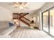 Bright living room features staircase to the second floor, office area, and sliding doors at 3808 Saxon Dr, New Smyrna Beach, FL 32169