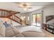 Open living room showcasing sliding glass doors to the outside patio and a staircase at 3808 Saxon Dr, New Smyrna Beach, FL 32169