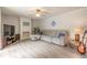 Relaxing living area with a plush sofa, decorative fireplace, and stylish ceiling fan at 3808 Saxon Dr, New Smyrna Beach, FL 32169